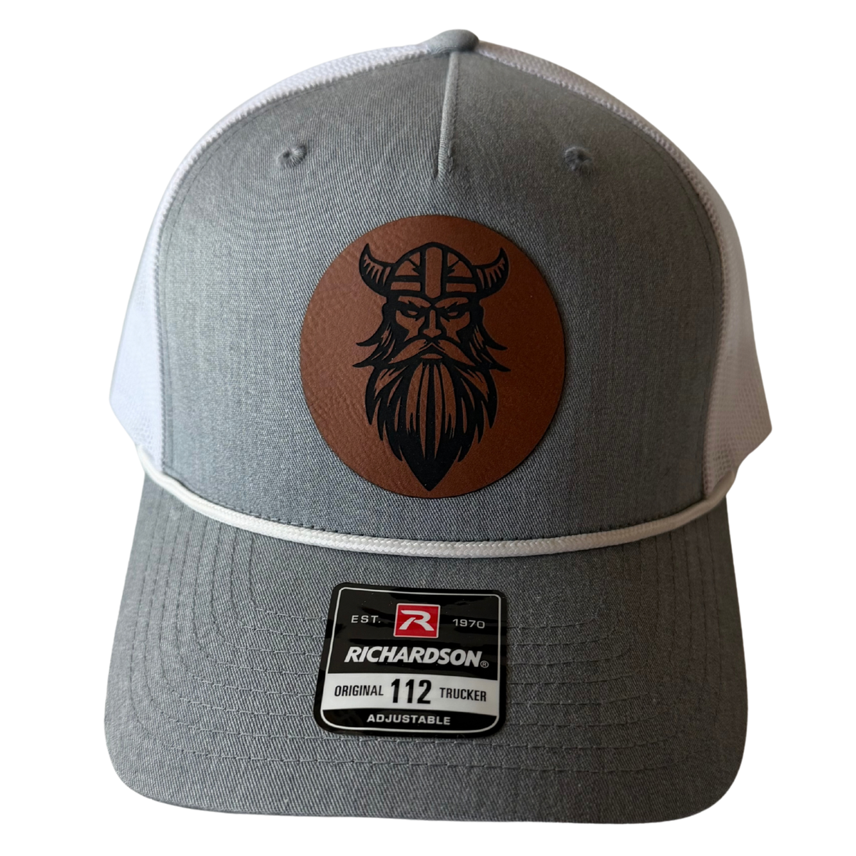 Front view of Veien heather grey and white cap with brown Viking leather patch and white rope detail.
