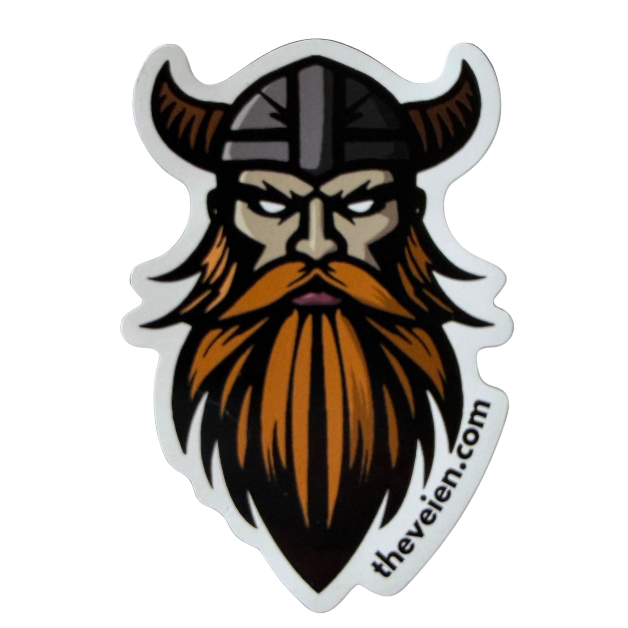 A die-cut magnet featuring a stylized cartoon Viking head with a long orange beard, black horned helmet, and gray facial details, shown on a plain white background. The text 'thevien.com.